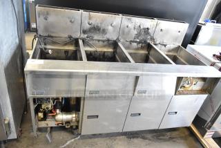 Pitco Frialator stainless steel 4-bay gas fryer on casters, commercial use, visible wiring, moderate wear, brand label present.