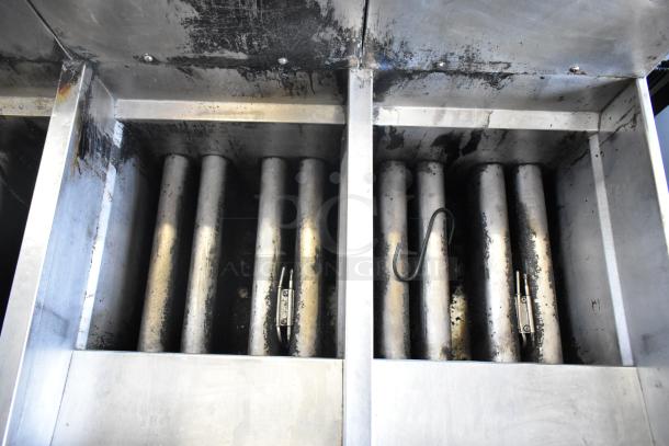 Pitco Frialator stainless steel 4-bay gas fryer, worn finish, on commercial casters. Interior shows signs of use.