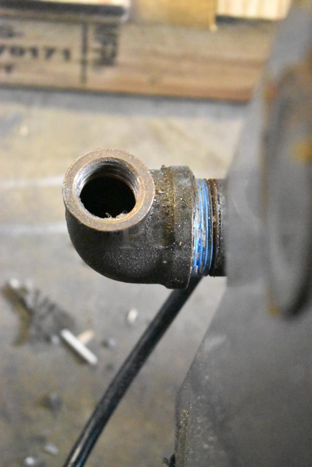 Close-up view of a pipe fitting on a Pitco Frialator commercial gas fryer, showing signs of wear and use.