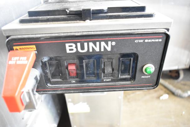 Bunn CWTF15-APS stainless steel commercial coffee machine with hot water dispenser, featuring control panel and labels.