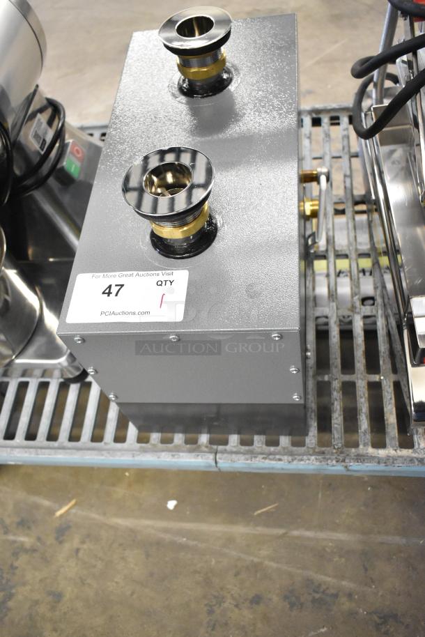 Brand new Hatco metal commercial water heater with minor scratches. Features brass fittings and two inlets. Auction tag indicates QTY: 1.