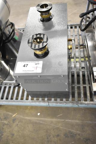 Brand new Hatco metal commercial water heater with minor scratches. Features brass fittings and two inlets. Auction tag indicates QTY: 1.