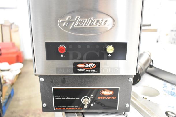 Brand new Hatco commercial water heater with minor scratches. Features metal construction, power indicators, model markings.