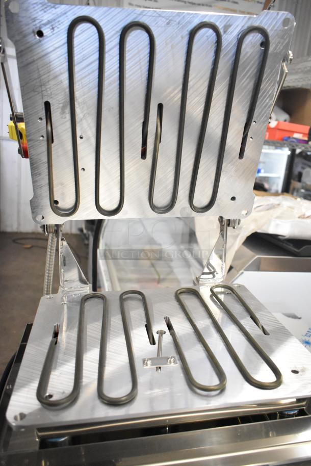 Brand new 2024 Pavoni Newcookmatic V1 stainless steel pastry press, 110 volts, 1 phase, visible heating elements, minor scratches.