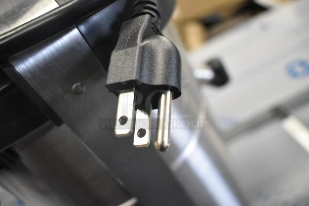 Stainless steel Robot Coupe J100 juicer, 120V, 1 phase, scratch and dent condition, showing power plug detail.