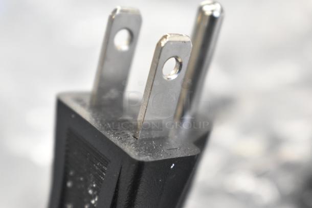 Close-up of a power plug for the AvaMix 928BX1100P blender. Black plastic with two prongs. Brand new condition.