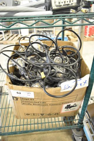 Box of assorted string lights with black cords in used condition, cardboard box labeled "62 QTY." Auction item on wire rack.
