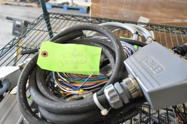 Bundle of assorted wires and cables with labeled green tag reading "823210 DB 4-11-23." Includes electrical connectors.