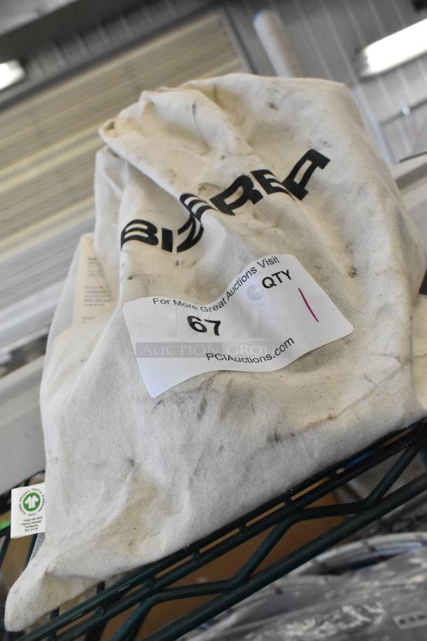 Brand new Bizerba meat slicer blade sharpener in packaging. Bag shows minor dirt, label indicates auction item #67.