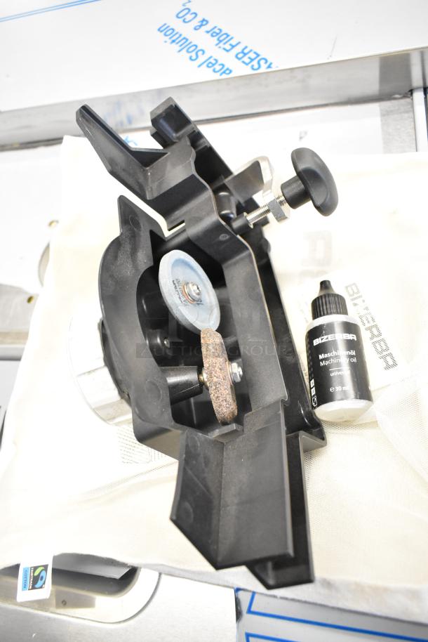 Brand new Bizerba meat slicer blade sharpener with minor scratches. Includes 30ml Bizerba machine oil and manual.