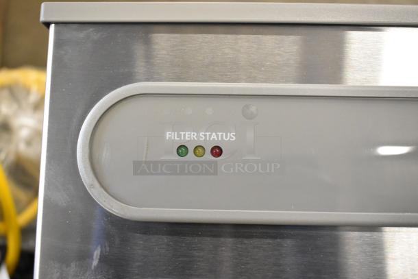 Brand new Elkay water bottle filler with drip tray, marked scratch and dent, filter status lights visible.