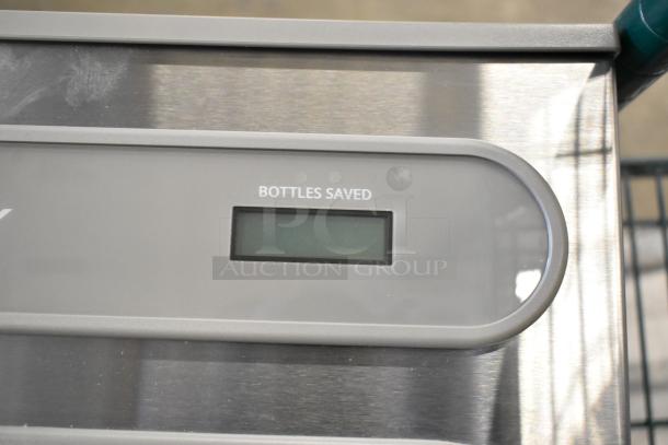 Brand new Elkay water bottle filler and drip tray, scratch and dent condition, with "Bottles Saved" display screen.