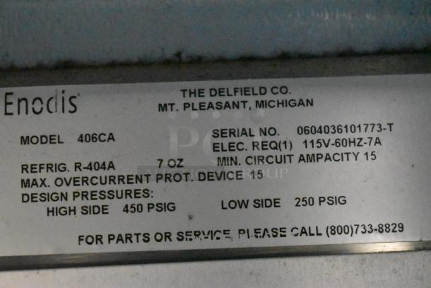 Delfield 406CA stainless steel undercounter cooler, 115V, on casters. Label shows model, serial number, and electrical details.