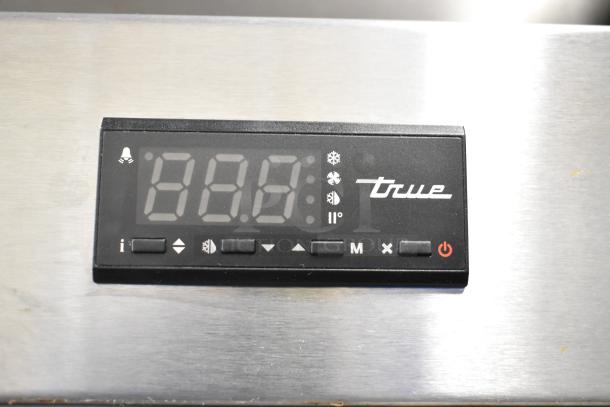 Digital display panel of 2019 True T-49-HC Reach In Cooler, showing logo and controls, stainless steel background.