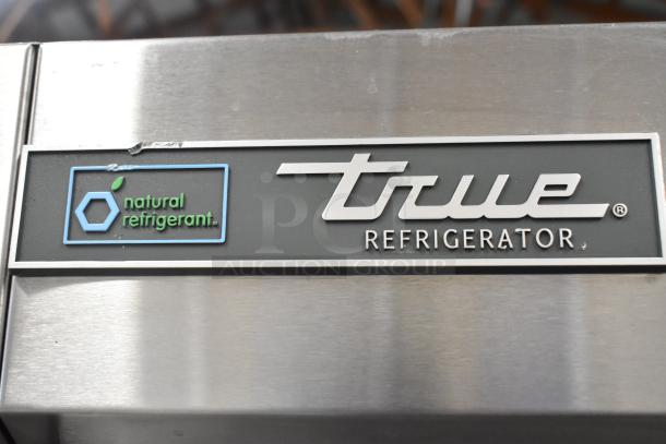 2019 True T-49-HC stainless steel commercial cooler, 2 doors, poly coated racks, 115V, 1 phase, "natural refrigerant" label.