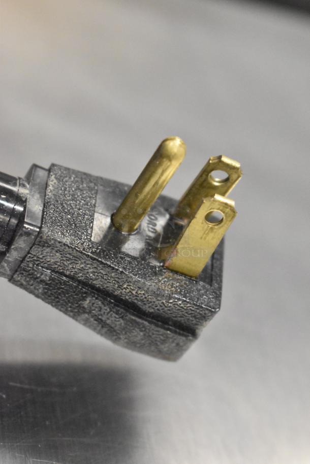 Close-up of a power plug from a 2019 True T-49-HC 2 Door Reach In Cooler, showing three-prong configuration.