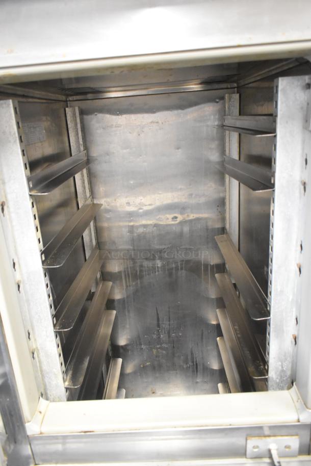 Victory RS-1D-S6 stainless steel reach-in cooler, two half-size doors, shelves visible, 115V, used condition.