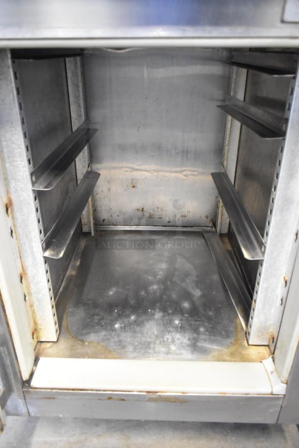 Victory RS-1D-S6 stainless steel commercial reach-in cooler, two half-size doors, 115 volts, used condition, visible interior wear.