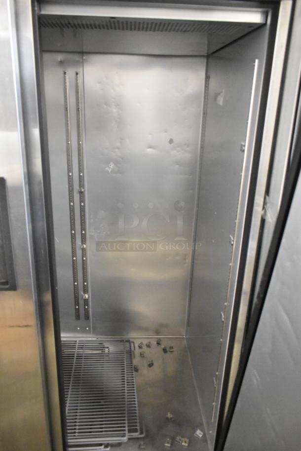 2024 True TG2R-2S-HC stainless steel commercial cooler, 2 doors, poly-coated racks, door needs reattachment, 115V, 1 phase.