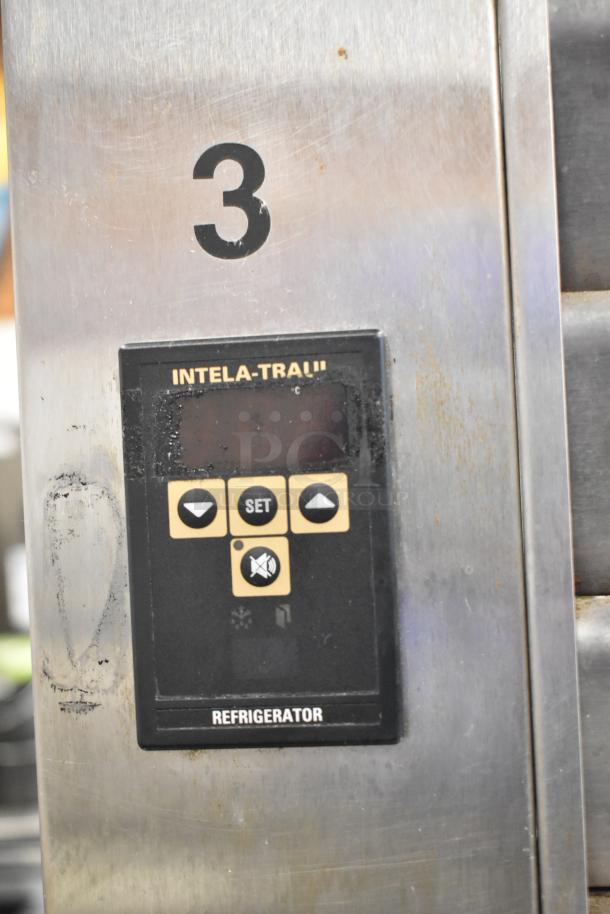 Traulsen stainless steel commercial cooler control panel with INTELA-TRAUL display, model details, and condition markings.
