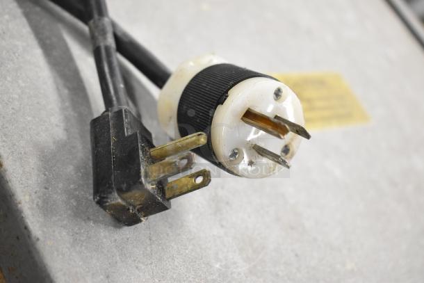 Close-up of an electrical plug for Traulsen stainless steel commercial cooler, 115 volts, 1 phase, in used condition.