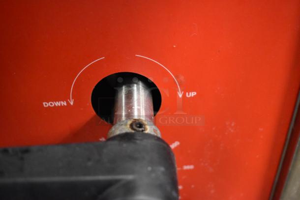 Vulcan stainless steel braising pan control knob, labeled "UP" and "DOWN," indicating adjustable tilt feature.