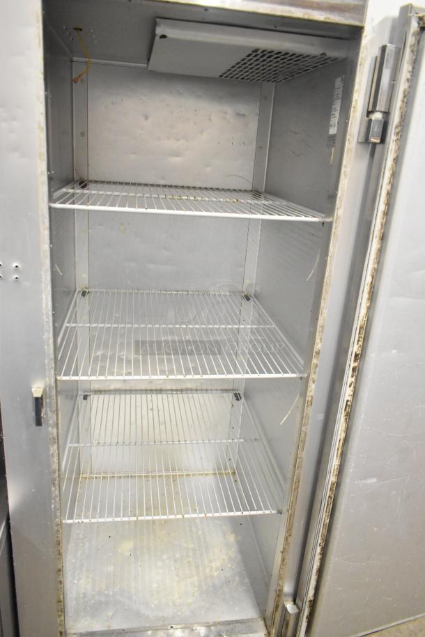 Traulsen G12010 stainless steel commercial single door reach-in freezer with racks, showing interior, 115V, 1 phase.