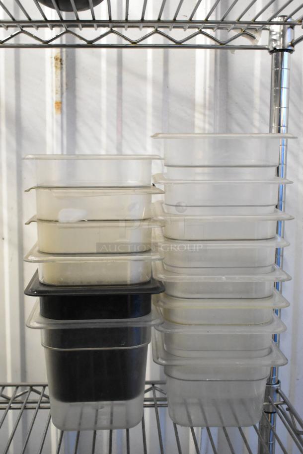 Lot of poly drop-in bins and containers, various sizes and colors, stacked on metal shelving. Shelving unit not included.