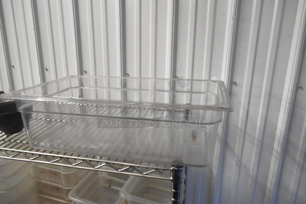 Lot of poly drop-in bins and containers on metal shelving, not included. Various sizes, clear plastic, good condition.