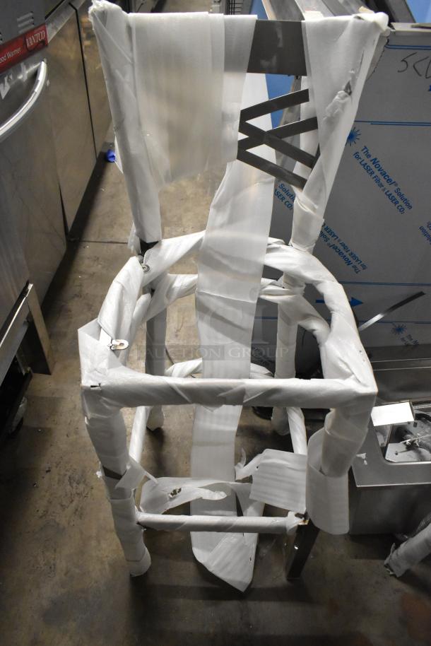 Lancaster Table & Seating gray metal bar height chair, crossback design, new with protective wraps, minor scratches.