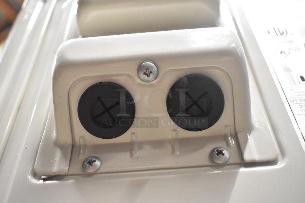 Pioneer YN018GLSI25RPH metal air conditioner compressor, 208-230 volts, 1 phase, with visible mounting screws and wiring ports.