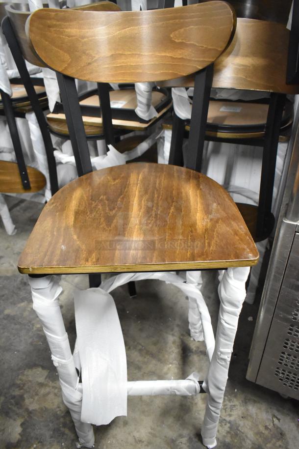 Lancaster Table & Seating black metal bar height chair, wooden back and seat, new scratch and dent condition, 12 available.