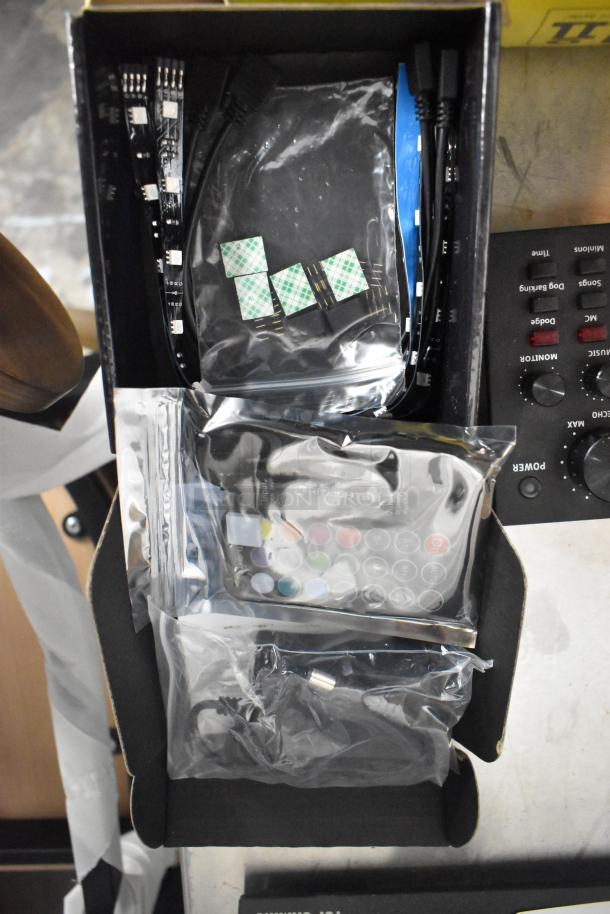 Box containing a HiLights Eclipse Kit with adhesive strips, connectors, remote control, and cables in sealed packaging.