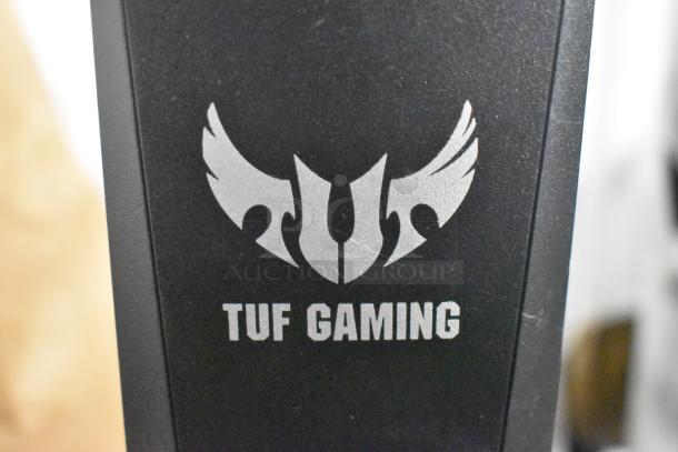 TUF Gaming Stand with logo, black finish, sturdy build. Ideal for gaming setups. Excellent condition, no visible wear.