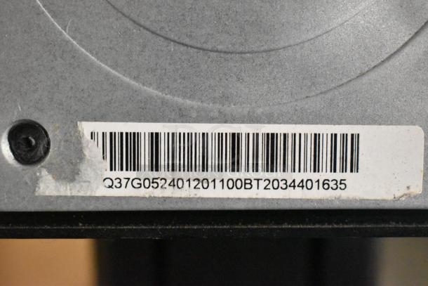 Tuf Gaming Stand with visible barcode. Model: Q37G052401201100BT2034401635. Solid construction, ideal for gaming setups.