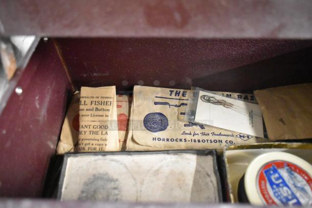 Vintage fishing tackle box with contents including Horrocks-Ibbotson packaging and various fishing gear. Good condition.