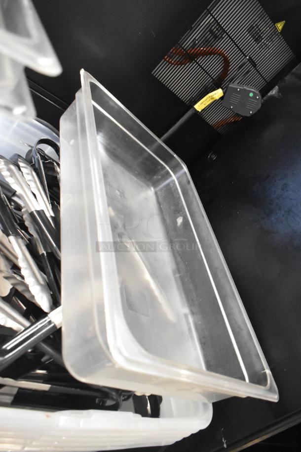 Lot of clear poly bins and metal utensils in used condition, featuring tongs with black grips. Ideal for kitchen use.