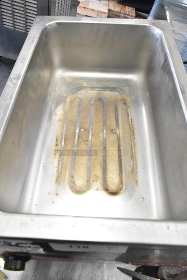 Avantco 177W50CKR stainless steel commercial food warmer, 120 volts, shows signs of use, heating elements visible.