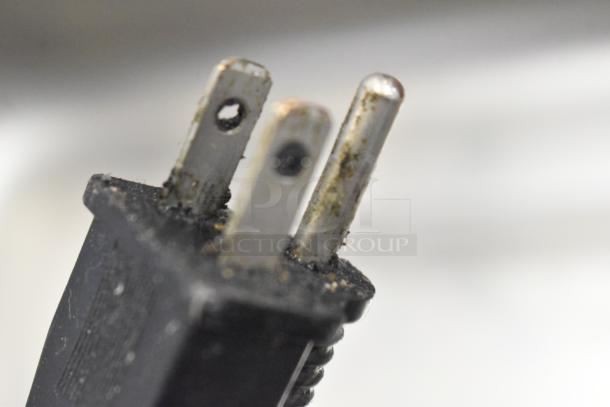 Close-up of a plug for Avantco 177W50 Stainless Steel Commercial Food Warmer. Some wear and grime visible on prongs.