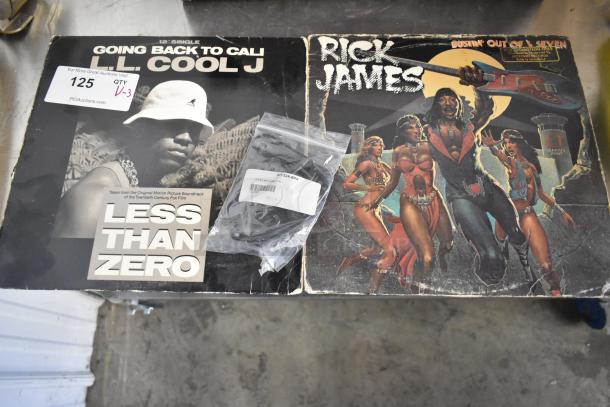 LL Cool J "Going Back to Cali" 12" single, Rick James "Bustin' Out of L Seven" LP, and KIT-32A-BKA belt slide kit in packaging.