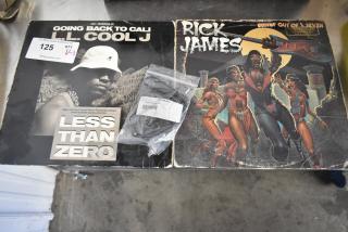 LL Cool J "Going Back to Cali" 12" single, Rick James "Bustin' Out of L Seven" LP, and KIT-32A-BKA belt slide kit in packaging.