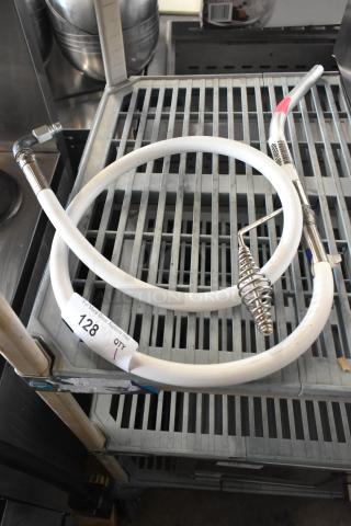 Hose assembly for oil filter with metal fittings and white tubing, good condition. Tag indicates item number 128.