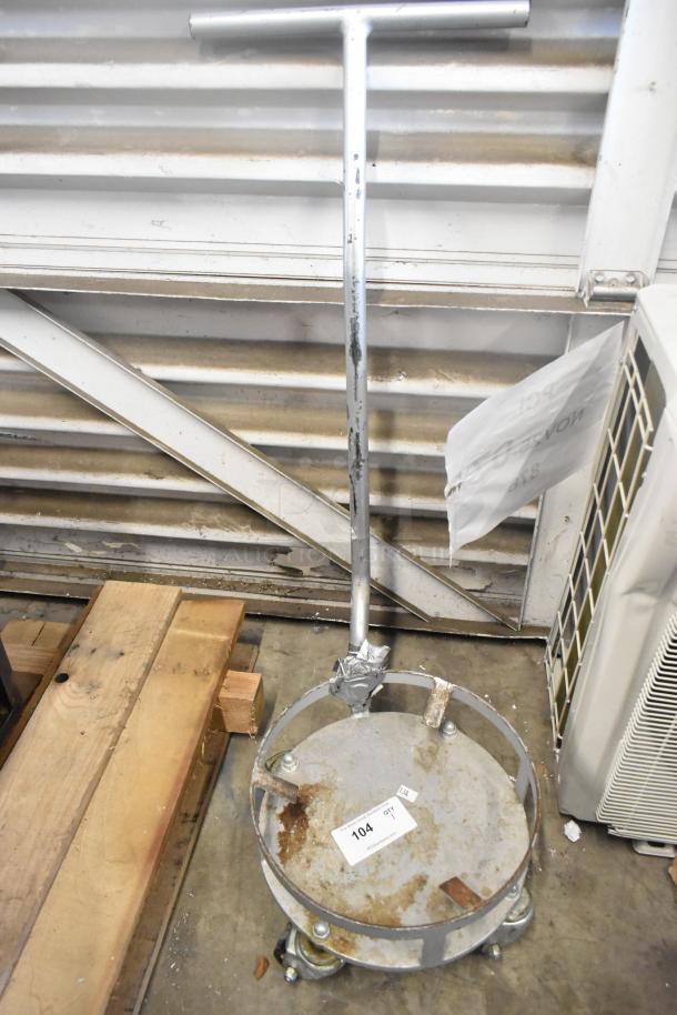 Metal bowl dolly with T-handle and commercial casters. Visible wear and rust. Item tag reads "104 QTY".