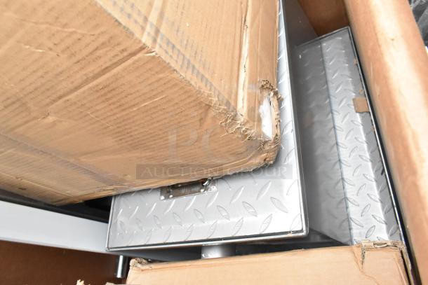 Alt text: New scratch and dent items including grease trap and wall cabinet, visible in packaging with noticeable box damage.