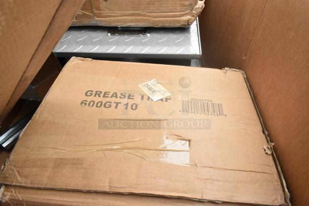 Cardboard box labeled "Grease Trap 600GT10" in new condition, part of a 6-item scratch and dent auction lot.