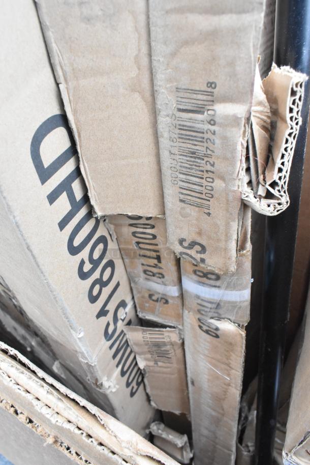 Boxes of brand new scratch and dent items, including a work table, legs, faucet, and chafer, with visible barcodes.