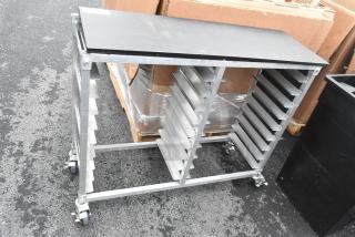 Metal double pan transport rack with commercial casters, featuring side slots for pans and sturdy construction.