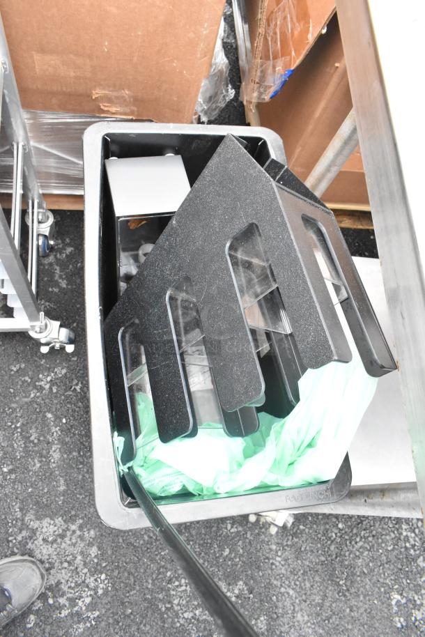 Black Poly Slim Jim trash can with contents, featuring a lid organizer. Includes green liner, good condition.