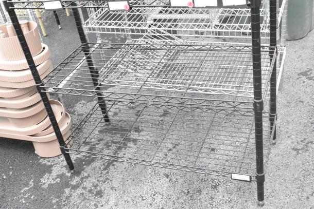 Black finish 6-tier wire shelving unit in used condition. Buyer must dismantle; consider freight charges.