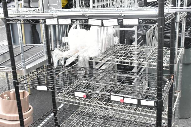 Black finish 6-tier wire shelving unit, sturdy design, pre-owned. Buyer must dismantle. Consider freight for shipping.